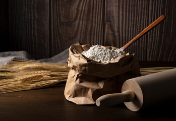 Fototapeta na wymiar Flour set against a dark wooden background
