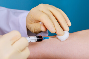 A nurse use a syringe to take a blood sample from a man to be tested for HIV AIDS