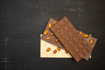some sweet and tasty different chocolate bars an black background