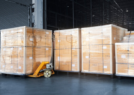 Stacked of Package Boxes Wrapped Plastic on Pallet Rack. Interior of Storage Warehouse. Shipping Warehouse Logistics. Industry Cargo Export- Import.