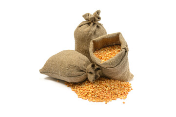 Peas in a bag, isolated on a white background.Split peas in burlap. Healthy food.Yellow split peas in a jute bag.Selective focus.