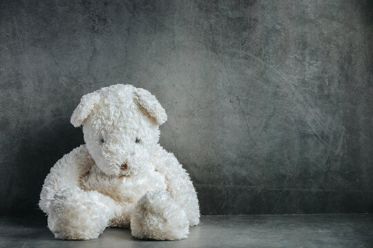 Teddy bear sad in an empty room, national child abuse prevention month