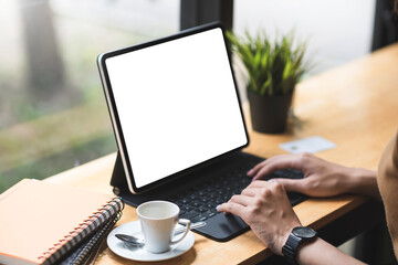 Mockup. woman hand printing jobs using a tablet keyboard at the office.