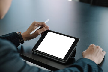 Mock up. Businessman using a tablet white blank screen at the office.