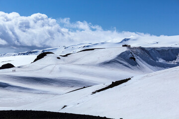 Sun and beautiful clouds over snowy landscape at Fimmvorduhals hiking trail