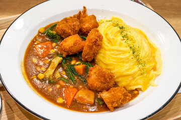 A tempting and delicious Japanese curry fried chicken omelet rice