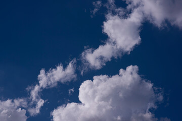 Beautiful blue sky background with tiny clouds. Natural cirrus cloud background.