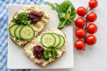 sandwich dip bread spread with salad vegetables on white porcelain plate 
