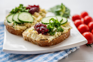 sandwich dip bread spread with salad vegetables on white porcelain plate 