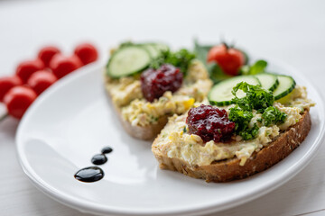 sandwich dip bread spread with salad vegetables on white porcelain plate 