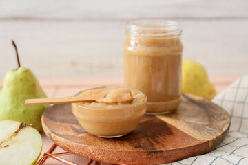 Tasty pear jam on wooden table
