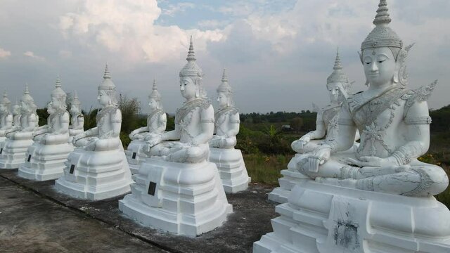 Row white buddha statue with blue sky