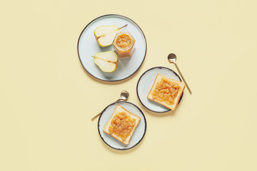 Jar of tasty pear jam with bread on color background