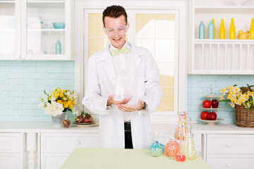 Chemist carries chemistry experiment in laboratory. Test-tubes with chemical reagent. Chemical Laboratory. Study of chemistry. Scientist at laboratory funny surprised by result of experiment.