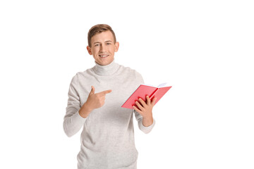 Young man with red book on white background