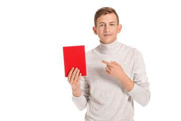 Young man with red book on white background