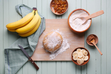 Ingredients for preparing banana cookies and dough on color wooden background