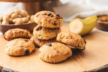 Board with tasty banana cookies, closeup