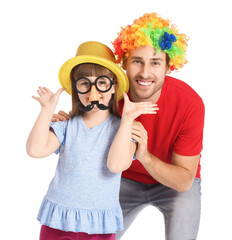 Little girl and her father in funny disguise on white background. April Fools Day celebration