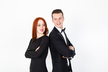 Man and woman actors performing on the stage, white background. Smiling man and woman with folded arms backs to each other on white background with copy space