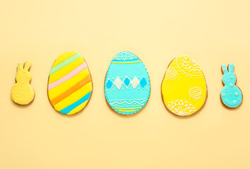 Tasty Easter cookies on color background