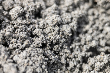 a blurry photo of the zoomed texture of the gray soil of the earth as a background. defocused