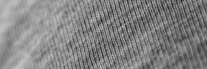 blurry grey knit fabric in zoomed in form as a background close up. defocused. banner