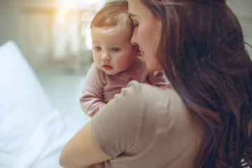 A young mother is holding her newborn baby. Mother of a nursing baby. Mother breastfeeding her baby. The family is at home. Portrait of a happy mother and child. High quality photo.