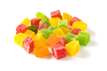 Multicolored cubes of sweet candied fruits isolated on white