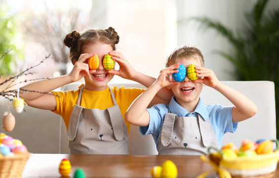 Cute kids with painted Easter eggs at home