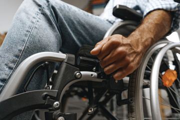 Obraz premium Unrecognizable disabled man sitting in a wheelchair