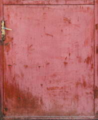 weathered and rusty red surface from a door with latch - a metal board background for a wallpaper