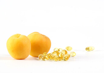 Vitamin pills capsules and apricot fruit healthy food good for immune system