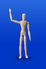 Greeting wooden toy figure on blue