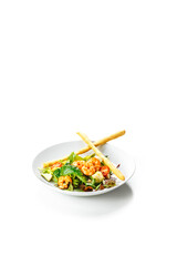 Fresh salad with shrimp, avocado and tomato cherry in bowl on white background.