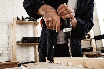Close up of a carpenter drilling a hole in timber