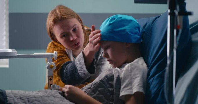 Mother discussing illness with son in clinic ward