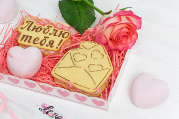 Gift wrap with heart shaped cookies and red rose