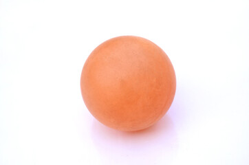 the orange color old cricket ball isolated on white background.