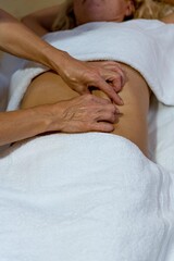 Chiromassage therapist giving a back massage to a client