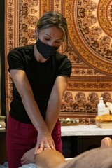 Masseuse giving a leg massage to a client