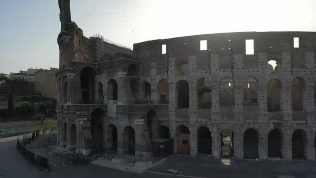Rays of sunlight pass through the cracks of the colosseum in Rome.
Aerial view of the colosseum at the first light of dawn