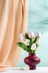 Fototapeta na wymiar vase with bouquet of beautiful tulips on color background