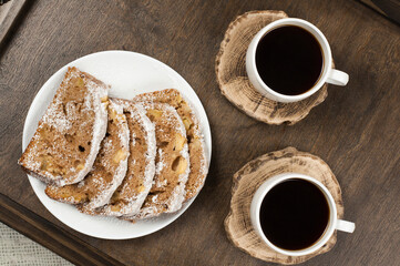 Two white cups of coffee on a wooden table tray. Breakfast in bed