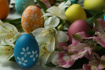 Color Easter eggs and alstroemeria flowers, close up