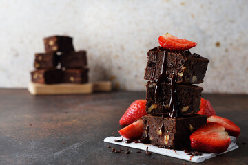Pieces of chocolate brownie with strawberries
