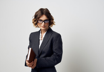 Woman in glasses business finance documents and black jacket shirt