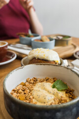 woman holding a bowl of cereal with milk