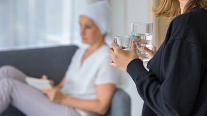 Loving daughter carrying medicine for sick mother