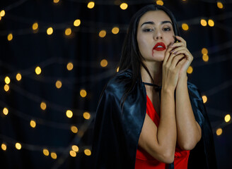 Gothic woman with red lips looking at camera